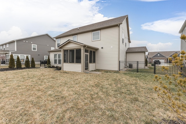 rear view of property with a yard and a sunroom