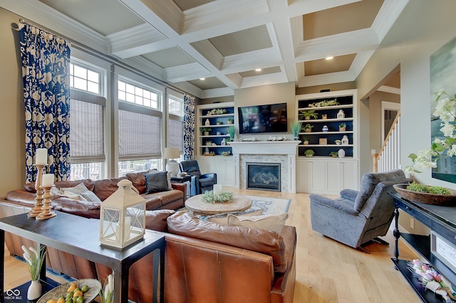 14445 Gainesway Cir, Fishers, IN 46040 - living room with light wood-style flooring, beam ceiling, coffered ceiling, a glass covered fireplace, and crown molding