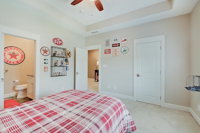 14445 Gainesway Cir, Fishers, IN 46040 - bedroom featuring light colored carpet, a ceiling fan, a raised ceiling, and connected bathroom