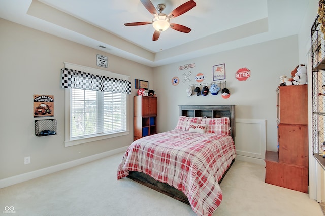 14445 Gainesway Cir, Fishers, IN 46040 - bedroom featuring light carpet, a raised ceiling, and a ceiling fan