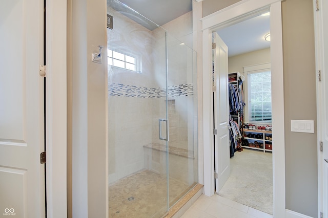 14445 Gainesway Cir, Fishers, IN 46040 - bathroom featuring a stall shower, healthy amount of natural light, a walk in closet, and tile patterned flooring