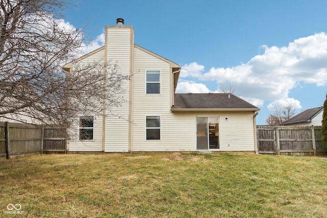 rear view of property featuring a lawn