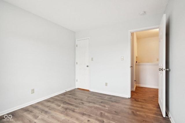 unfurnished bedroom featuring dark hardwood / wood-style floors