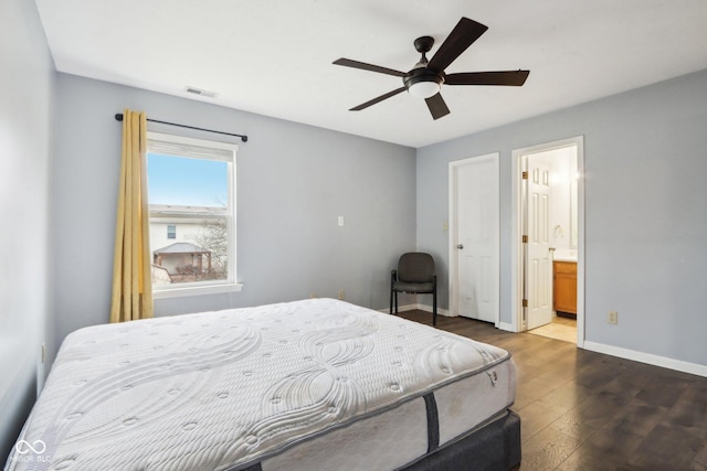 bedroom featuring dark wood-type flooring, ceiling fan, and ensuite bath