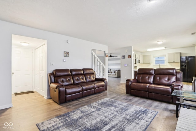 living room featuring hardwood / wood-style floors and a textured ceiling