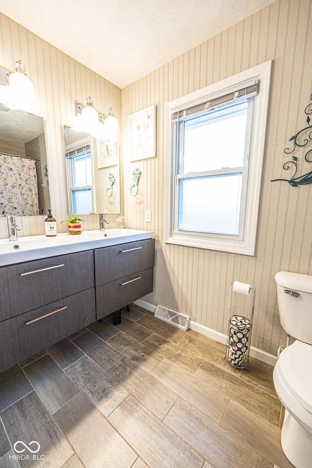 bathroom featuring vanity, toilet, and hardwood / wood-style floors