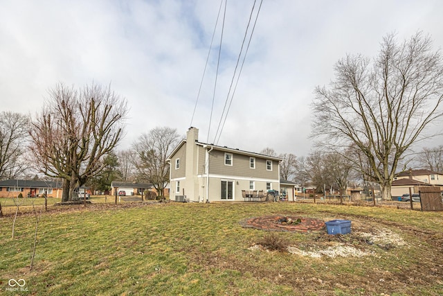 rear view of property with a yard