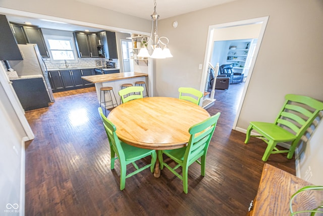 dining area featuring dark hardwood / wood-style floors and sink