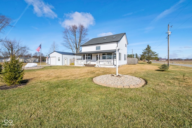 back of house featuring an outbuilding, a yard, covered porch, and a garage