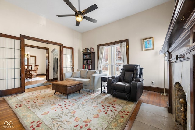 living room featuring hardwood / wood-style floors and ceiling fan