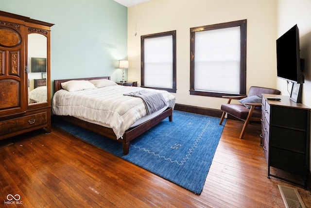 bedroom featuring dark hardwood / wood-style flooring