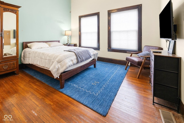 bedroom with dark hardwood / wood-style flooring