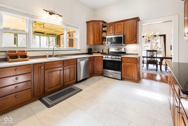 kitchen with sink, a notable chandelier, and appliances with stainless steel finishes