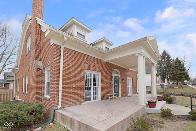 back of property featuring covered porch