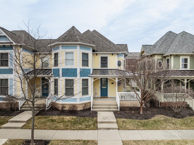 victorian-style house featuring covered porch