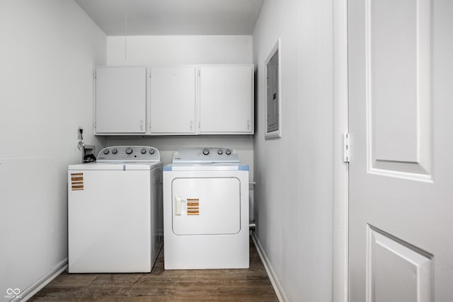 laundry area with cabinets, dark hardwood / wood-style flooring, electric panel, and washing machine and dryer