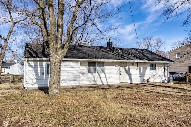 rear view of house with a yard