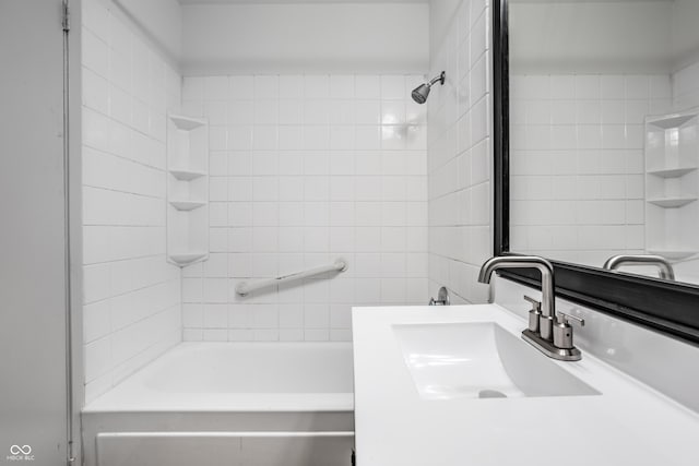 bathroom with sink and tiled shower / bath combo