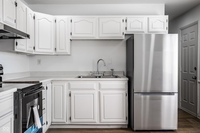 kitchen with white cabinetry, black range with electric cooktop, and stainless steel refrigerator