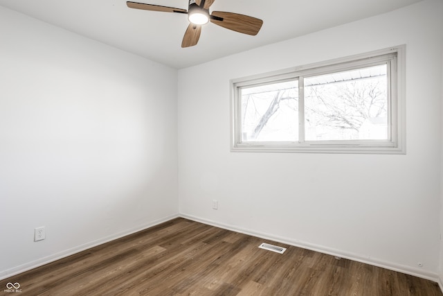 unfurnished room with ceiling fan and dark hardwood / wood-style flooring