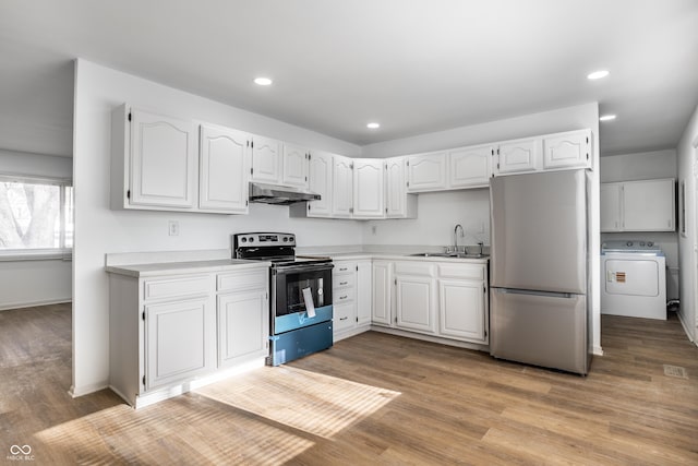 kitchen with sink, light hardwood / wood-style flooring, appliances with stainless steel finishes, washer / clothes dryer, and white cabinets