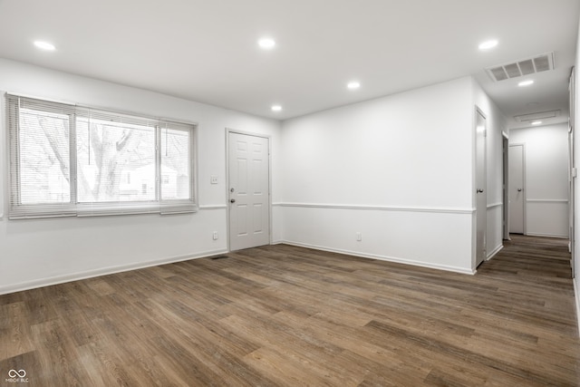 spare room with dark wood-type flooring