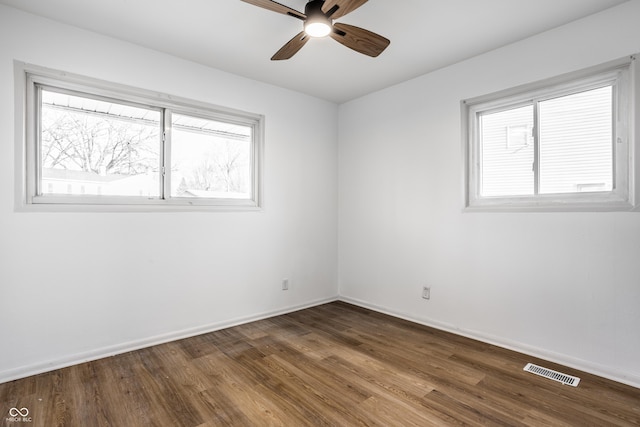 spare room with hardwood / wood-style floors and ceiling fan