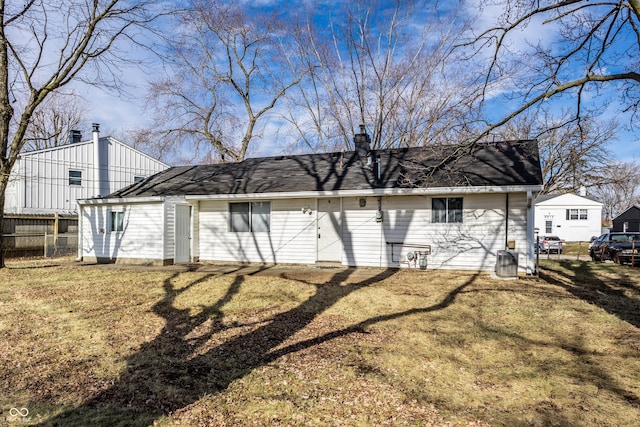 rear view of property featuring a yard