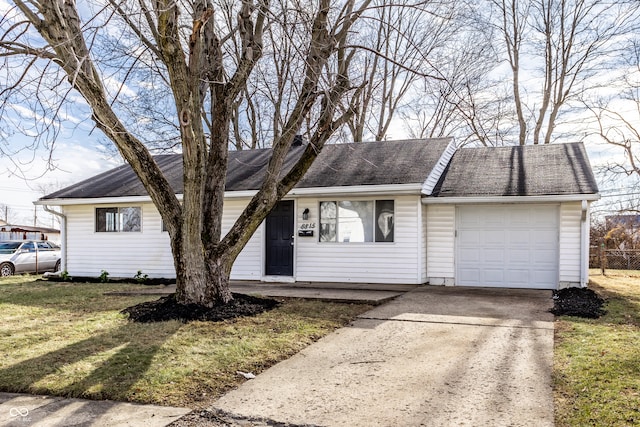 ranch-style house with a garage and a front lawn