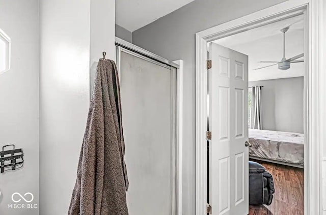 bathroom featuring hardwood / wood-style floors, ceiling fan, and walk in shower