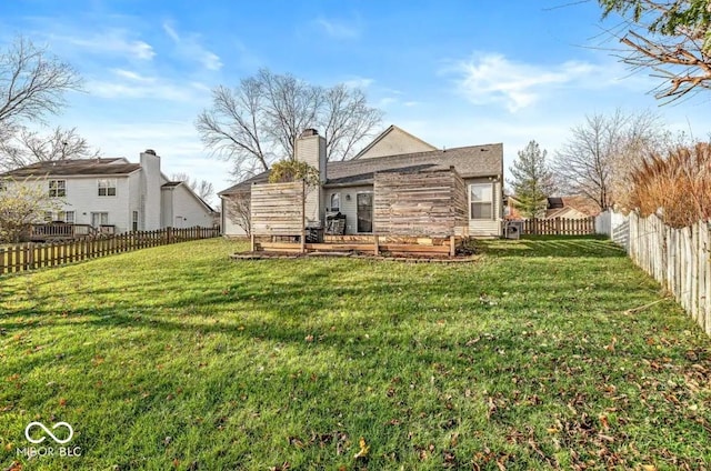 rear view of house with a yard