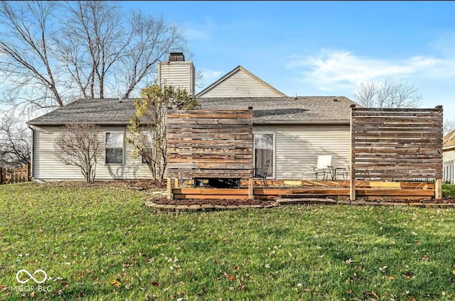 rear view of house featuring a lawn