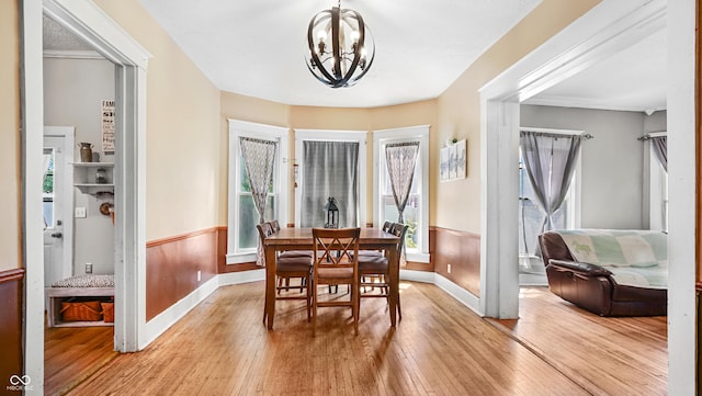 dining space with a chandelier and light hardwood / wood-style flooring