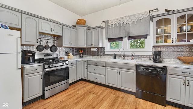 kitchen with sink, gray cabinetry, white refrigerator, stainless steel range with gas stovetop, and dishwasher