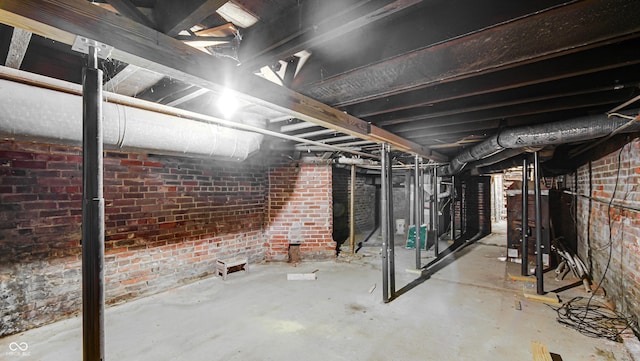 basement featuring brick wall