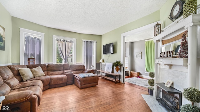 living room with hardwood / wood-style floors and a textured ceiling