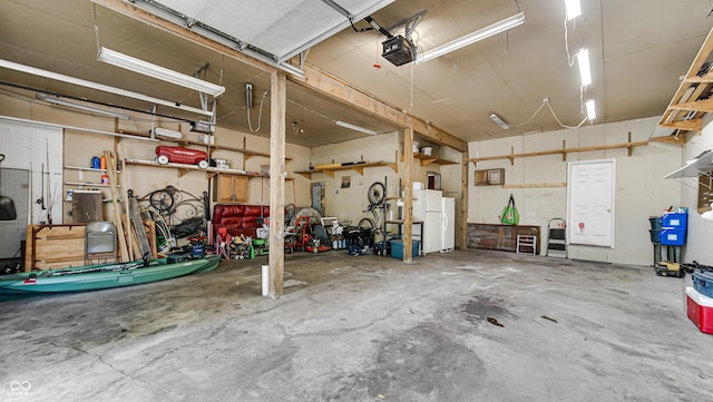 garage featuring a garage door opener, white fridge, and a workshop area