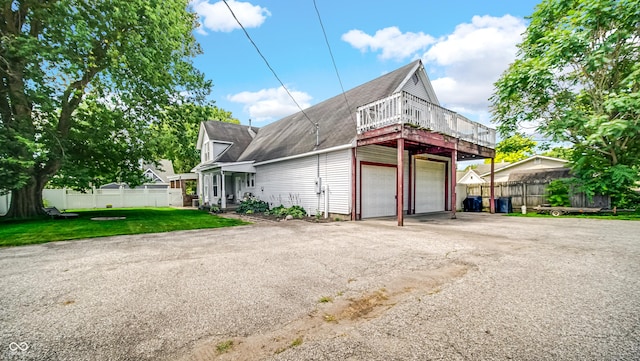 exterior space featuring a garage and a front yard