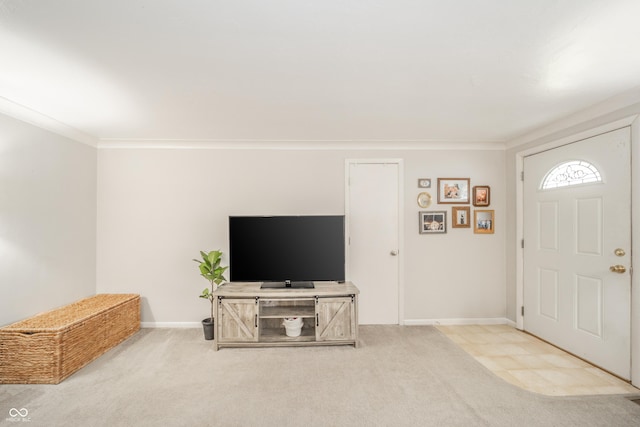 carpeted foyer entrance with ornamental molding