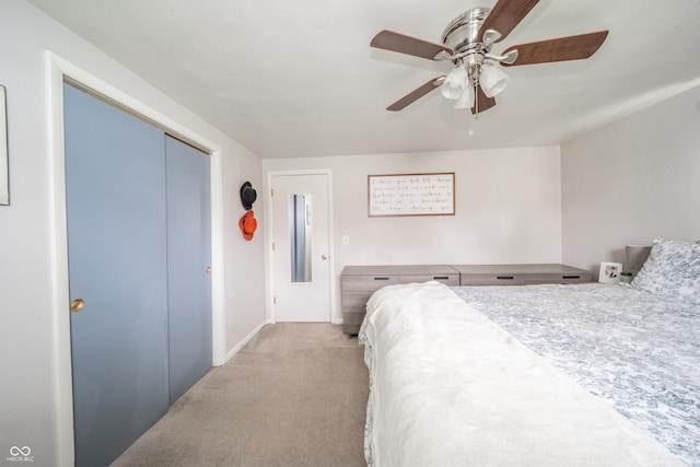 carpeted bedroom with a closet and ceiling fan