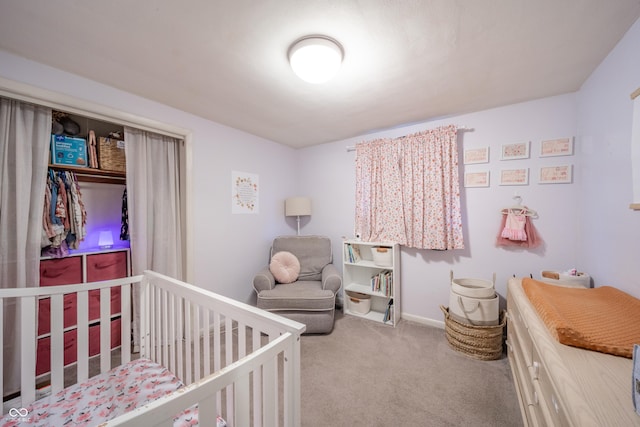 bedroom with carpet floors and a nursery area