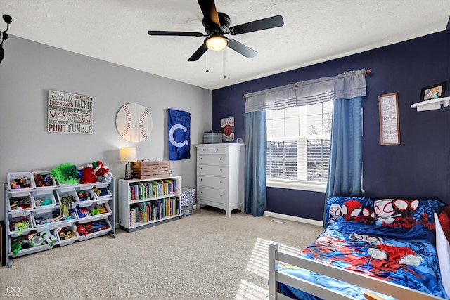 bedroom with ceiling fan, a textured ceiling, and carpet