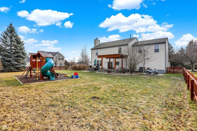 back of house with a yard, a playground, and a patio area