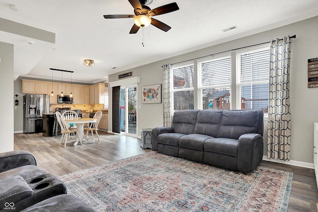 living room with ceiling fan and light wood-type flooring