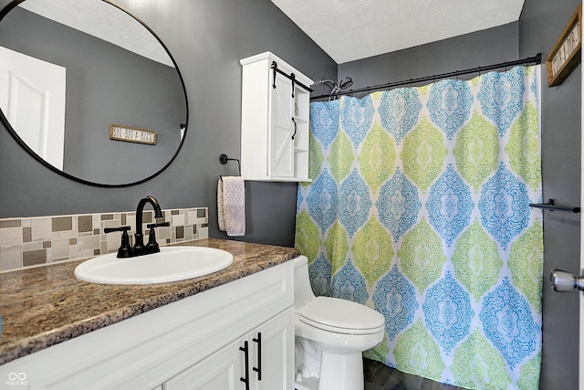 bathroom featuring toilet, tasteful backsplash, a textured ceiling, vanity, and a shower with shower curtain