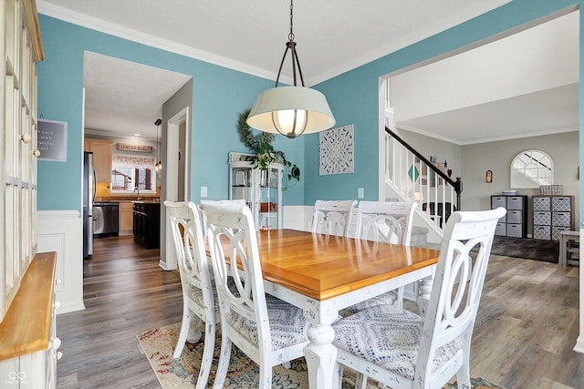 dining area with dark wood-type flooring, ornamental molding, and a wealth of natural light