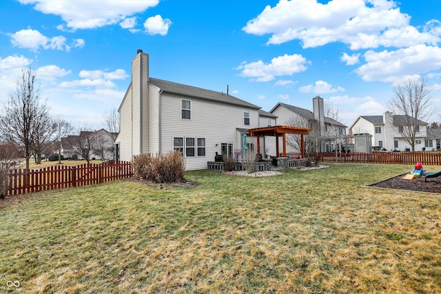 rear view of property with a yard and a patio area