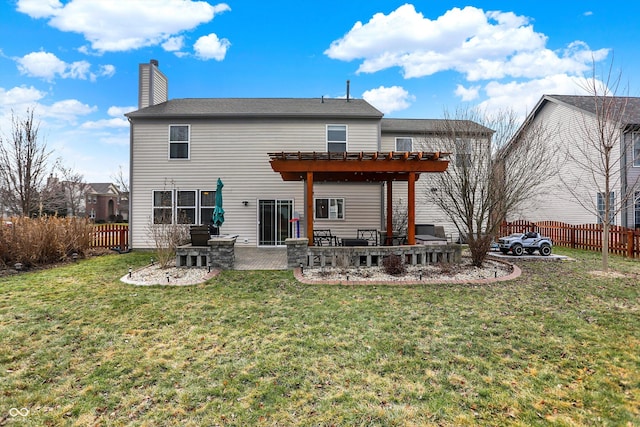 back of house with a yard, a pergola, and a patio area