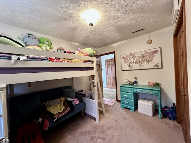 carpeted bedroom with a textured ceiling