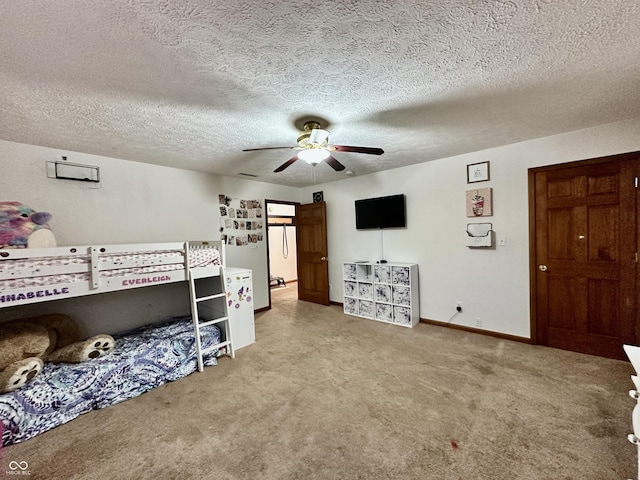 carpeted bedroom with ceiling fan and a textured ceiling